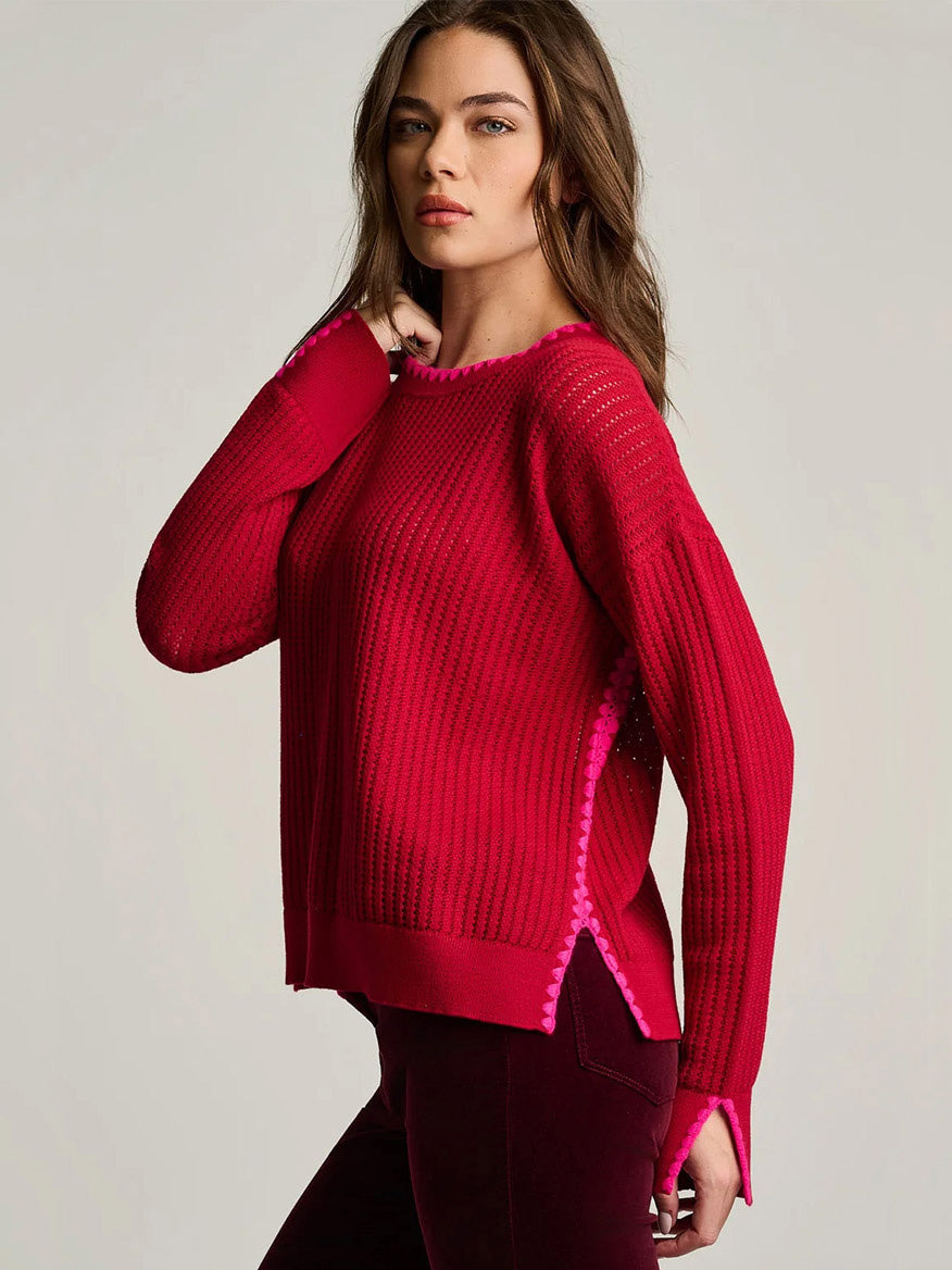 Lisa Todd Power Stitch Cotton Pullover in Spice Red, a relaxed-fit, red ribbed-knit cotton sweater with pink novelty stitch detailing along the neckline, cuffs, and side seams.