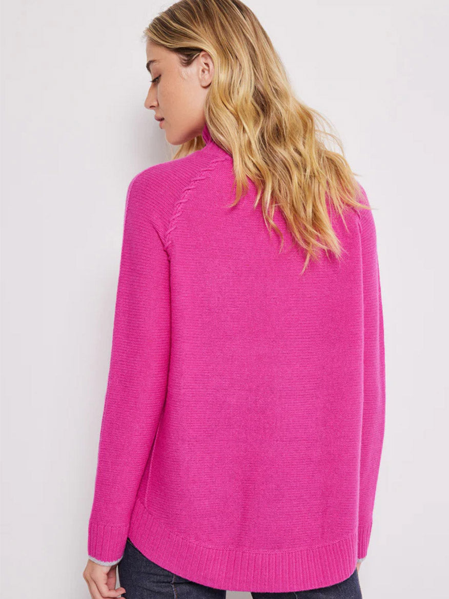 Woman in a Lisa Todd Soft Supply Mock Neck Sweater in Rhubarb viewed from the back.