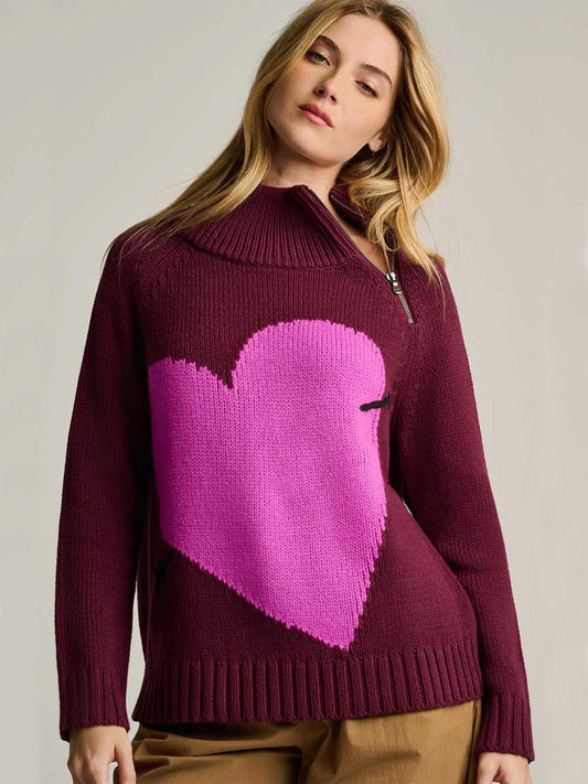 Lisa Todd Take Aim Sweater in Wine, a chunky cotton knit sweater with a high zippered collar and a large, bright pink heart motif on the front.