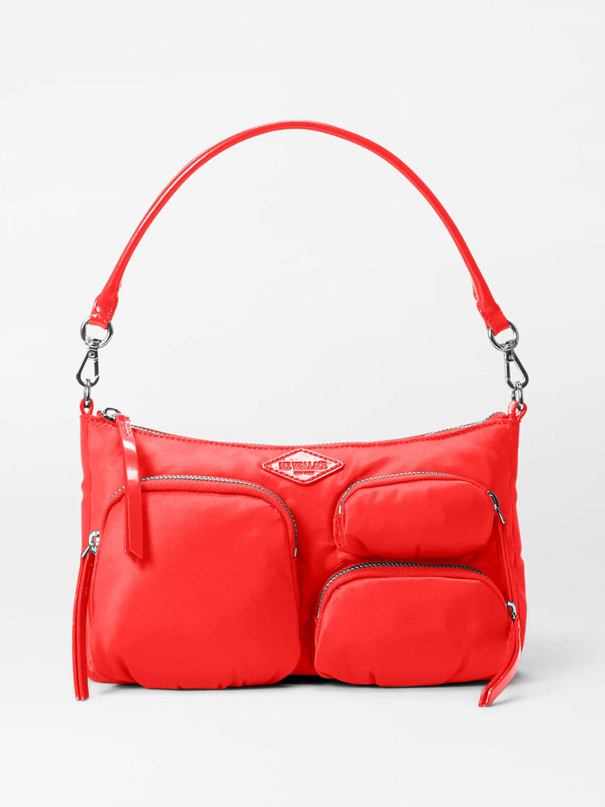 Introducing the MZ Wallace Chelsea Petite Shoulder Bag in Bright Cherry Bedford: a chic handbag crafted from durable nylon with luxurious Italian leather trim. It features three front zippered pockets, a comfortable shoulder strap, and elegant silver hardware. Perfect for on-the-go style.