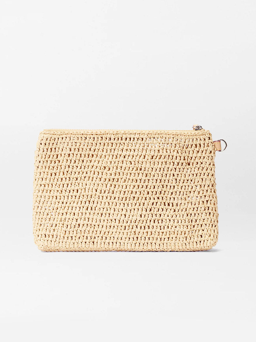 The MZ Wallace Crochet Clutch in Crochet/Camel, a rectangular woven beige summer bag with a zipper closure, is shown against a plain white background.