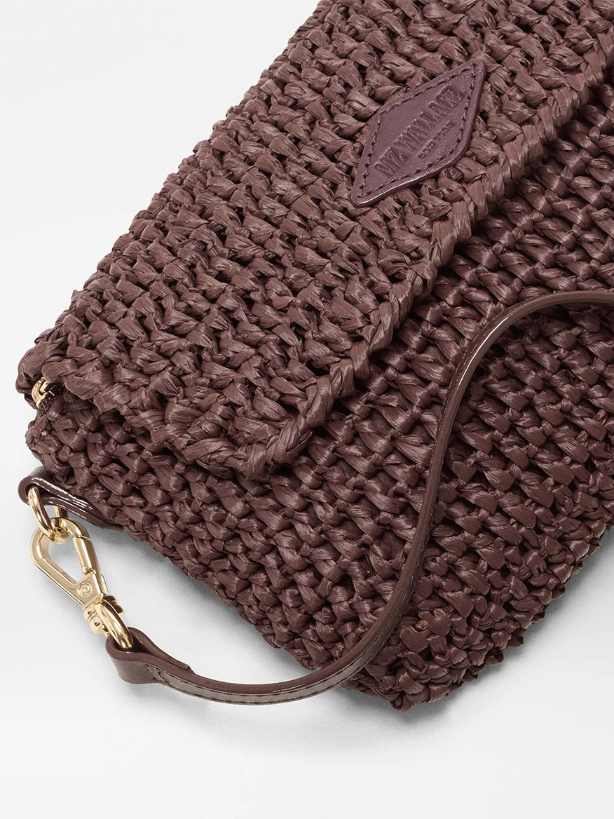 Close-up of the MZ Wallace Crochet Convertible Crossbody in Brown Crochet, featuring a flap closure, Italian leather strap, and gold hardware against a white background.