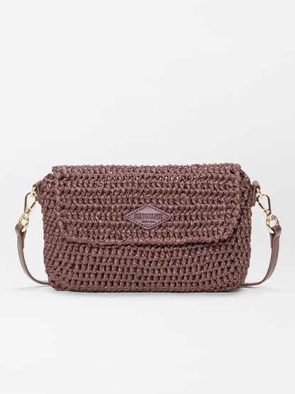 The MZ Wallace Crochet Convertible Crossbody in brown crochet, a small rectangular shoulder bag with flap closure, gold hardware, and adjustable strap, is shown against a plain white background.