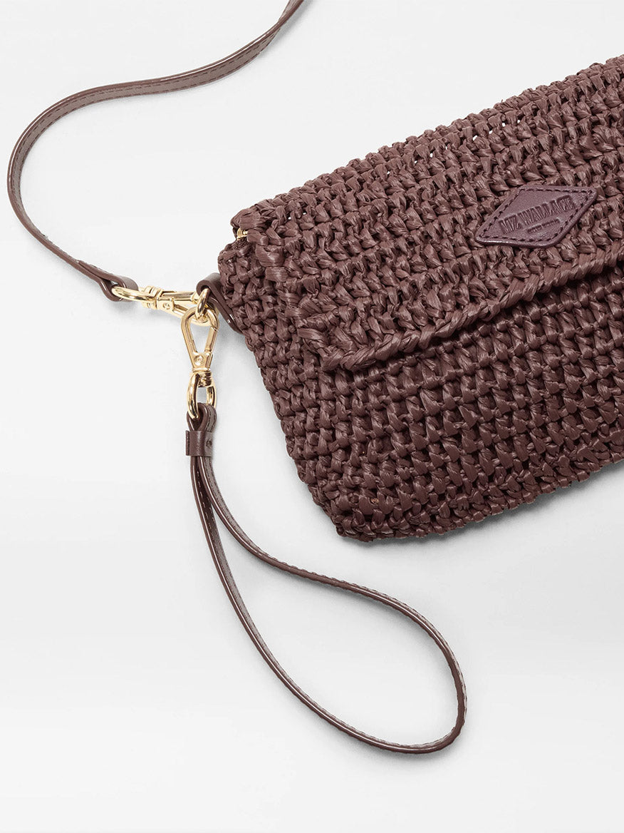 The MZ Wallace Crochet Convertible Crossbody in Brown Crochet features gold hardware, a flap closure, and a detachable crochet wristlet strap, shown on a light background.