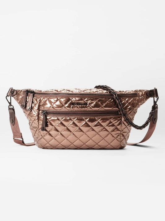 The MZ Wallace Crosby Crossbody Sling Bag in Copper Metallic Lacquer Oxford is a quilted, metallic bronze sling bag with Italian leather trim, featuring zipper closures and adjustable shoulder straps for a stylish hands-free option against a plain background.