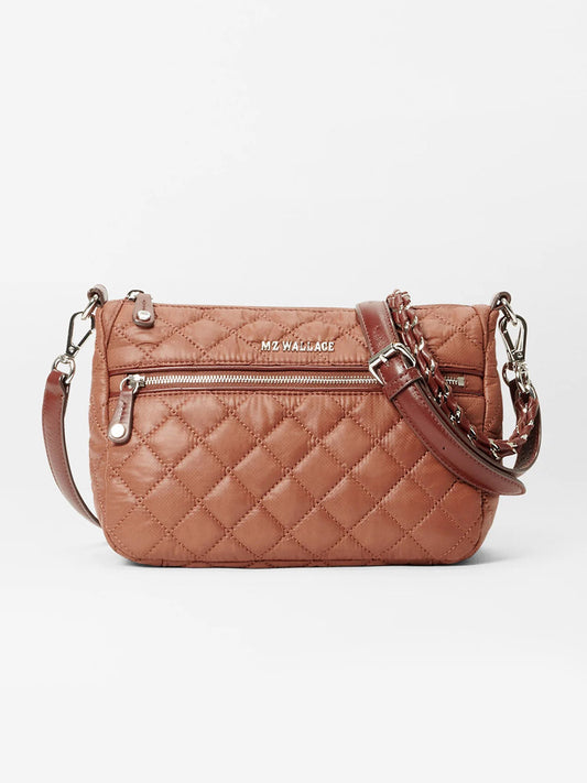 The MZ Wallace Crosby Ella Crossbody in Terracotta Oxford is a brown quilted bag with an adjustable chain-accented strap, front zipper pocket, and Italian leather trim.