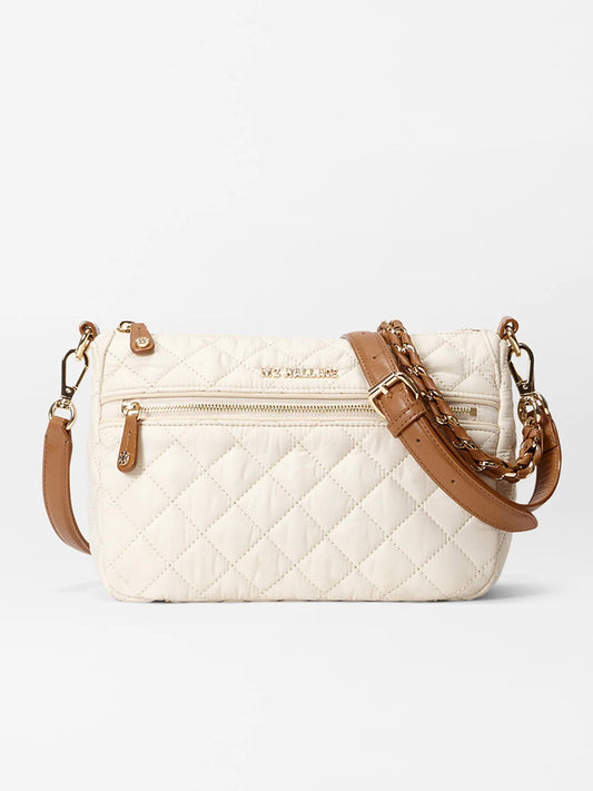 The MZ Wallace Crosby Ella Crossbody in Sandshell Oxford with Brown features a cream quilted-nylon body, Italian leather trim, front zip pocket, gold-tone hardware, and an adjustable brown shoulder strap.