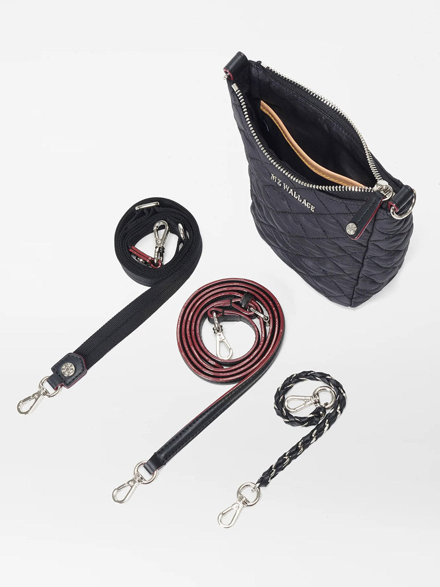 A MZ Wallace Crosby Go in Black Oxford with a zipper and three different styles of detachable, adjustable straps on a white background.