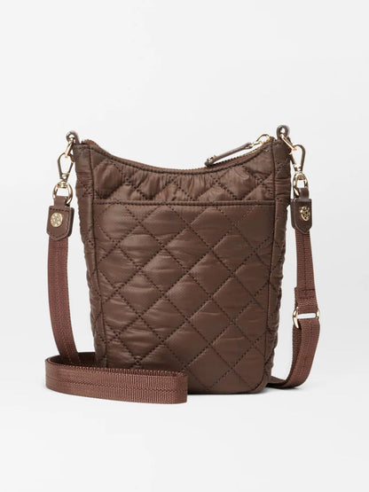 The MZ Wallace Crosby Go in Walnut Oxford is a small, quilted, crossbody bag featuring an adjustable strap and a zipper closure, elegantly accented with Italian leather trim.