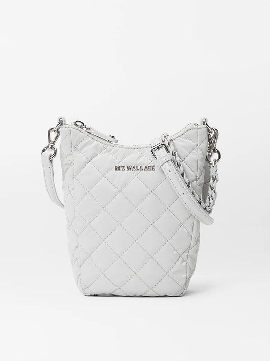 White quilted MZ Wallace Crosby Go bag in Pebble Liquid Oxford with a chain strap and adjustable nylon crossbody strap detail.