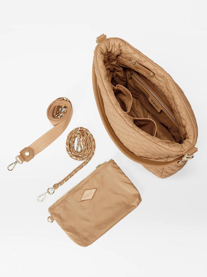 The MZ Wallace Crosby Hobo in Caramel Oxford features an open interior, a detachable strap, a braided handle, and a separate pouch, displayed on a white background.