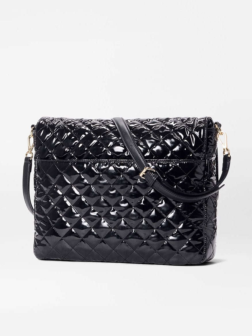 The MZ Wallace Crosby Lock Large Crossbody in Black Lacquer Oxford, crafted from black quilted patent leather with a flap closure and adjustable shoulder strap, is displayed against a plain white background.
