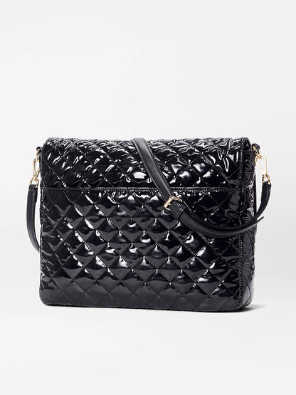 The MZ Wallace Crosby Lock Large Crossbody in Black Lacquer Oxford, crafted from black quilted patent leather with a flap closure and adjustable shoulder strap, is displayed against a plain white background.