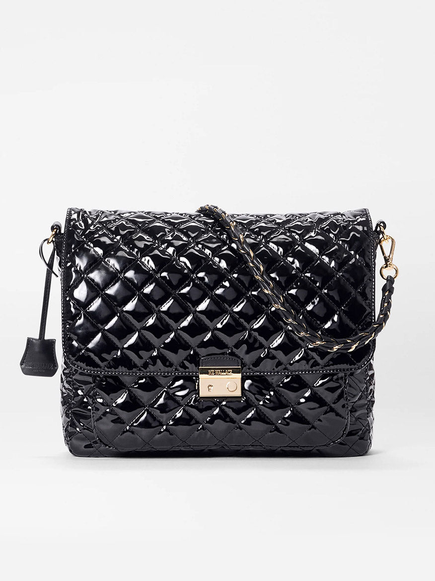 The MZ Wallace Crosby Lock Large Crossbody in Black Lacquer Oxford features quilted patent leather, a gold chain strap, and metal clasp, shown on a plain white background—perfect as an elegant designer bag.