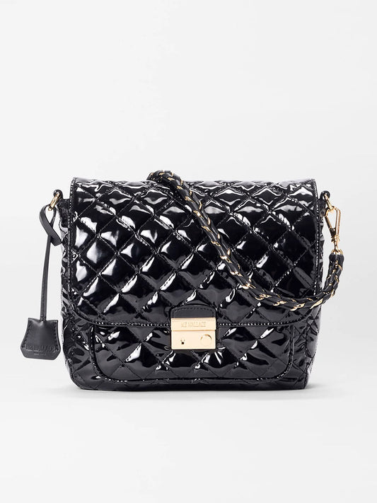The MZ Wallace Crosby Lock Medium Crossbody in Black Lacquer Oxford features quilted black oxford fabric, a chain strap, gold-tone hardware, and a front flap closure for a chic, elegant look.