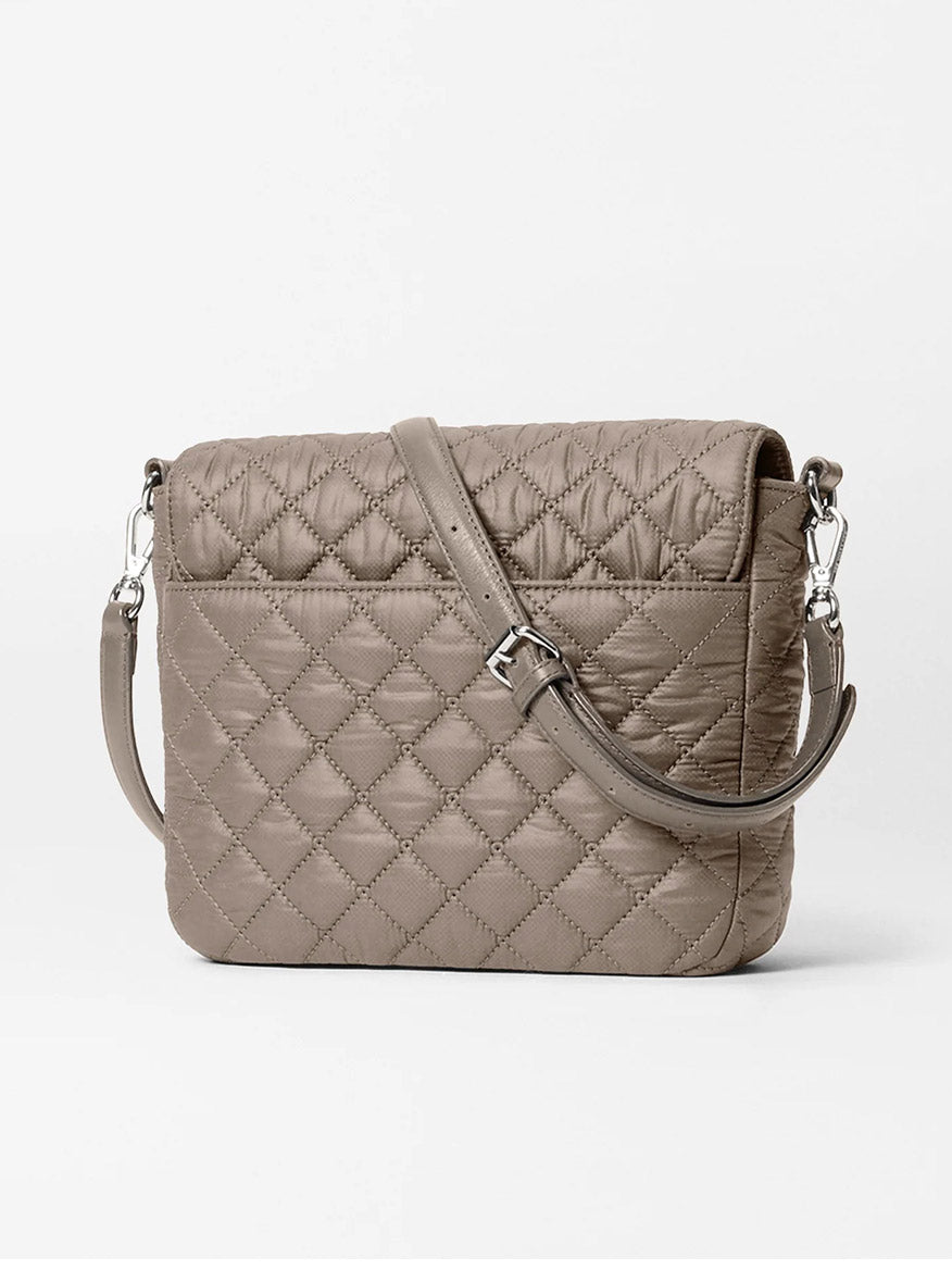 The MZ Wallace Crosby Lock Medium Crossbody in Morning Dove Oxford, featuring quilted taupe nylon with a diamond pattern, silver hardware, and an adjustable strap, is showcased as a stylish crossbody against a white background.