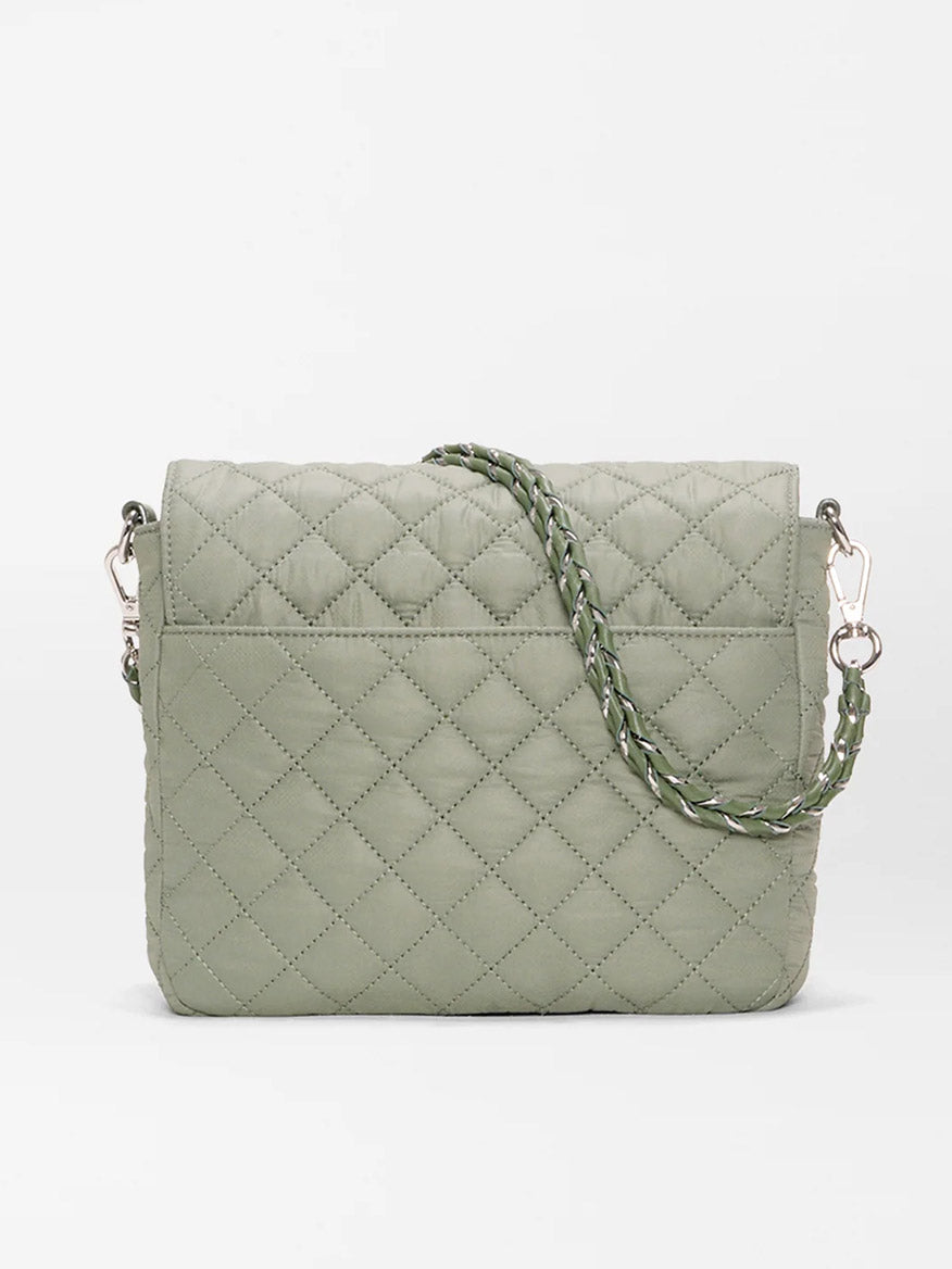 The MZ Wallace Crosby Lock Medium Crossbody in Agave Green Oxford is a quilted designer bag with a braided strap and silver hardware, shown against a plain white background.