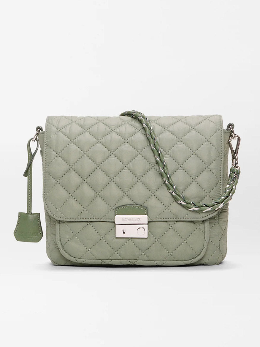 The MZ Wallace Crosby Lock Medium Crossbody in Agave Green Oxford features quilted nylon, a braided strap, front flap with metal clasp, and a small tag—shown on a plain white background.