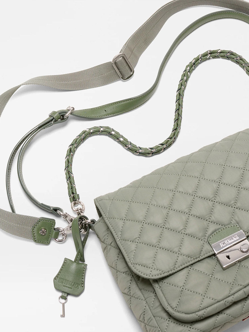 An MZ Wallace Crosby Lock Medium Crossbody in Agave Green Oxford, featuring quilted nylon, a silver clasp, braided shoulder strap, canvas crossbody strap, and key charm, shown on a white background.
