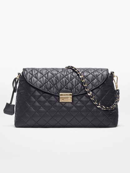 The MZ Wallace Crosby Lock Shoulder in Black Oxford features quilted black leather, a gold turn-lock clasp, chain and Italian leather strap, and a small leather tag, shown on a white background.