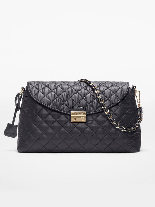The MZ Wallace Crosby Lock Shoulder in Black Oxford features quilted black leather, a gold turn-lock clasp, chain and Italian leather strap, and a small leather tag, shown on a white background.