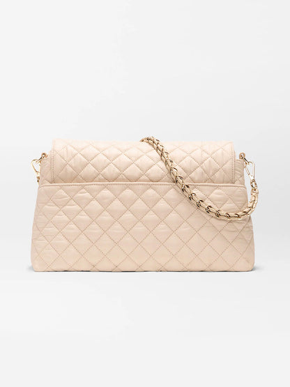 The MZ Wallace Crosby Lock Shoulder in Buff Oxford, crafted from Italian leather with a gold chain strap, is displayed against a plain white background.