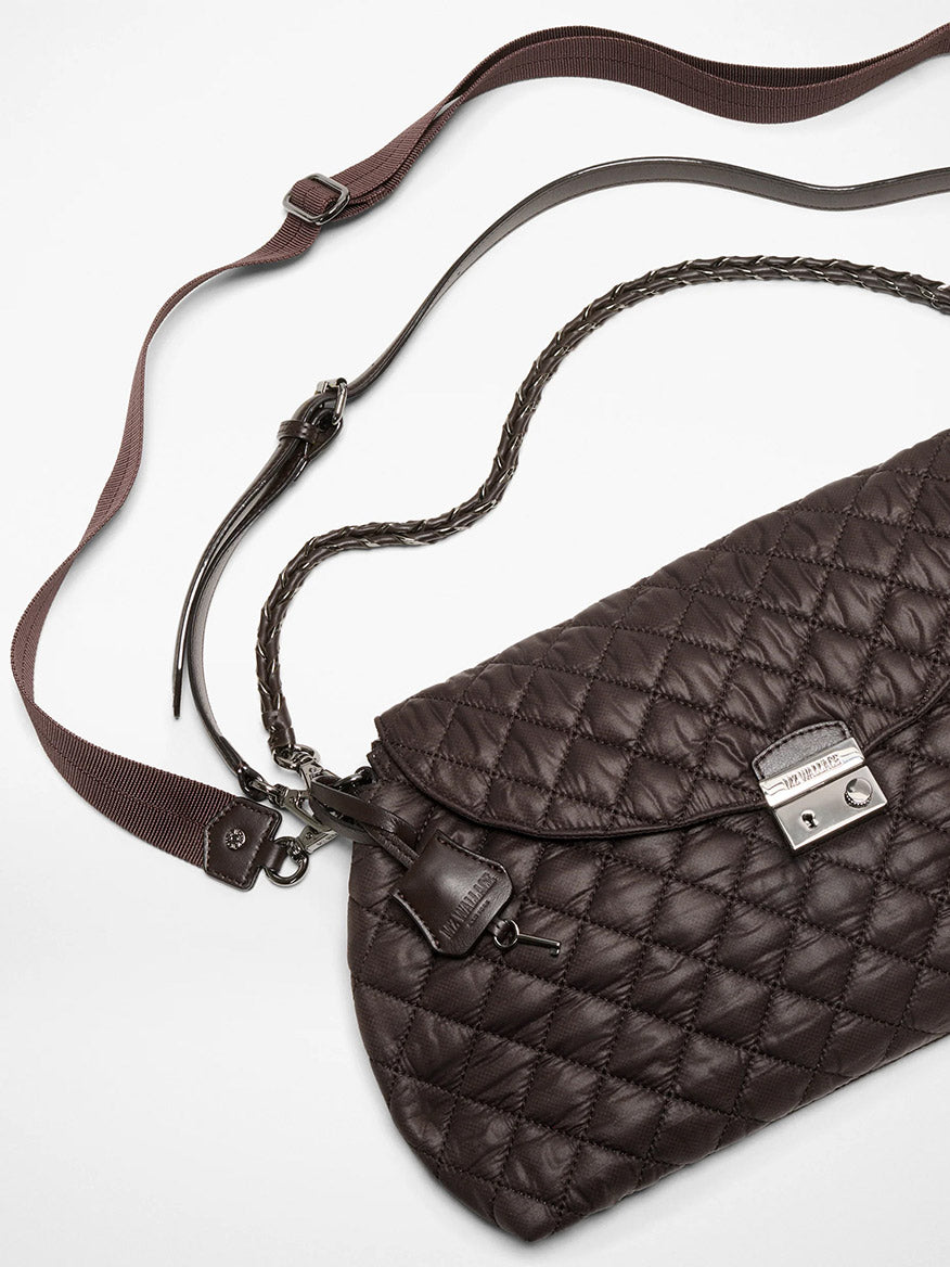 The MZ Wallace Crosby Lock Shoulder in Espresso Oxford features quilted dark brown leather, a silver clasp, zip top closure, adjustable brown crossbody strap, and braided handle, shown against a white background.