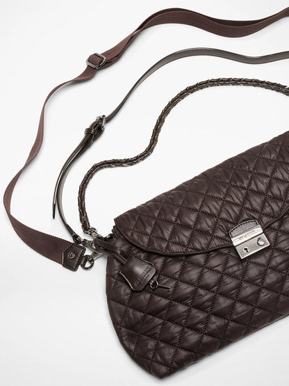 The MZ Wallace Crosby Lock Shoulder in Espresso Oxford features quilted dark brown leather, a silver clasp, zip top closure, adjustable brown crossbody strap, and braided handle, shown against a white background.