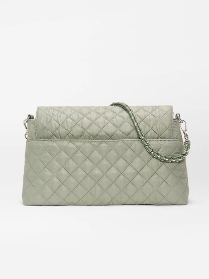 The MZ Wallace Crosby Lock Shoulder in Agave Green Oxford features a quilted design, flap closure, braided shoulder strap, and Italian leather trim, shown against a plain white background.