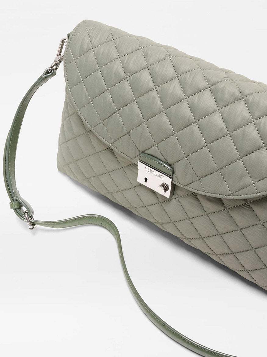 The MZ Wallace Crosby Lock Shoulder in Agave Green Oxford features a quilted design, Italian leather trim, silver clasp, and detachable/interchangeable straps, shown against a white background.