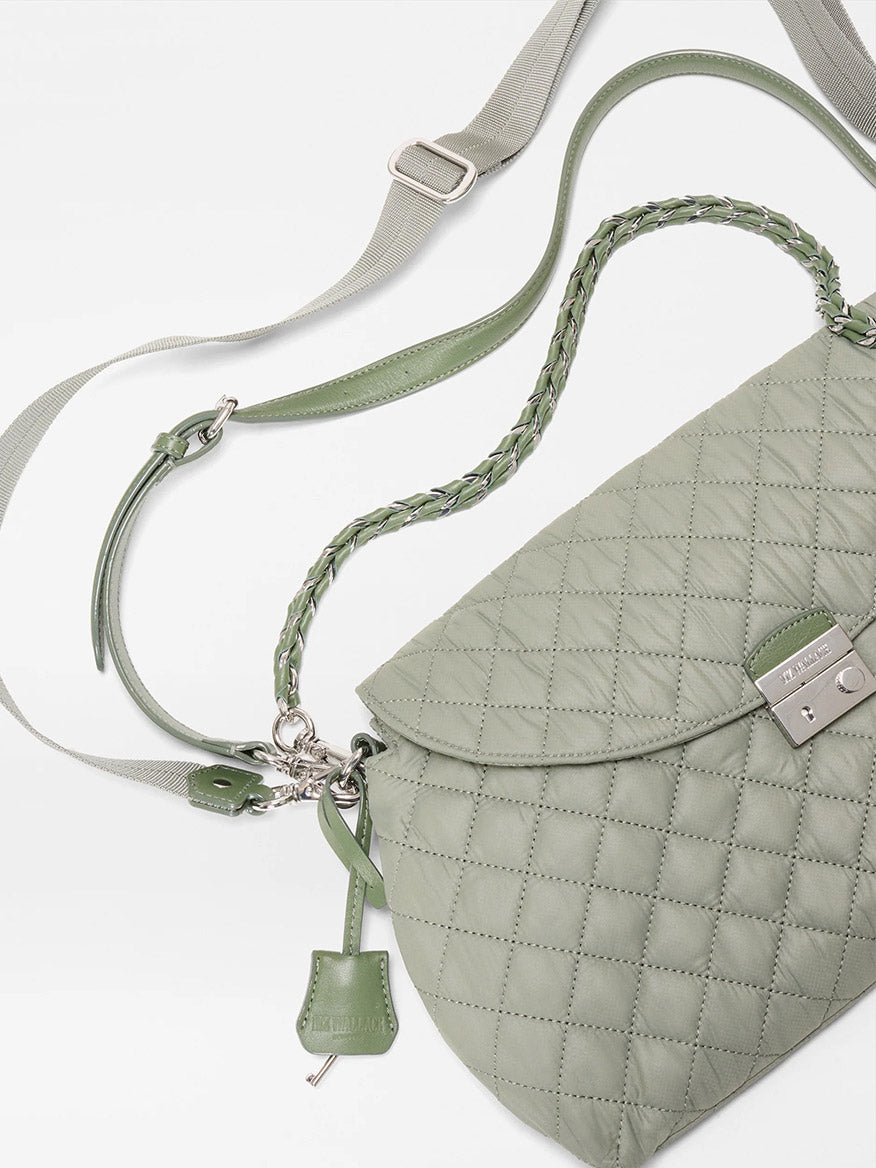 The MZ Wallace Crosby Lock Shoulder in Agave Green Oxford features a quilted design, braided shoulder strap, adjustable crossbody strap, Italian leather trim, and silver clasp lock, shown on a white background.