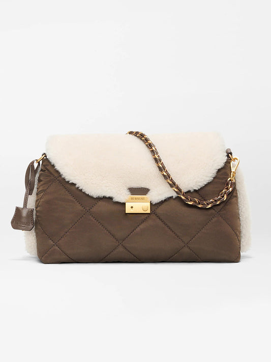 The MZ Wallace Crosby Lock Shoulder in Shearling & Walnut features a quilted brown nylon body, shearling flap, gold chain strap, Italian leather trim, and gold clasp, shown against a plain white background.