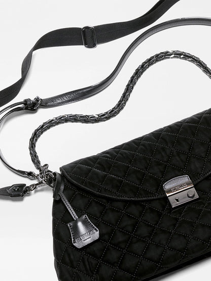 Black MZ Wallace Crosby Lock Shoulder in Black Velvet Finish bag featuring a metal closure, braided leather handle, and an adjustable nylon crossbody strap.