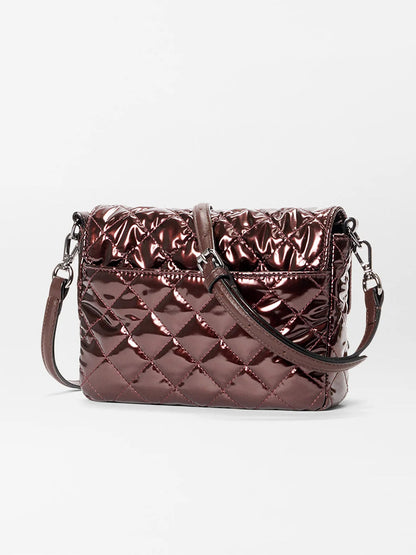 The MZ Wallace Crosby Lock Small Crossbody in Bordeaux Lacquer Oxford features a diamond-quilted pattern and adjustable strap, shown against a plain white background.