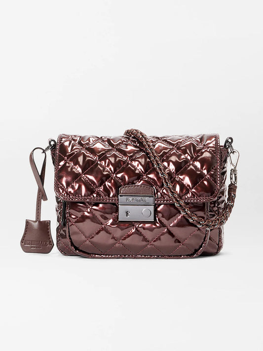 The MZ Wallace Crosby Lock Small Crossbody in Bordeaux Lacquer Oxford, featuring a metallic quilted design, chain strap, front flap closure, and small leather tag, is displayed against a plain white background.