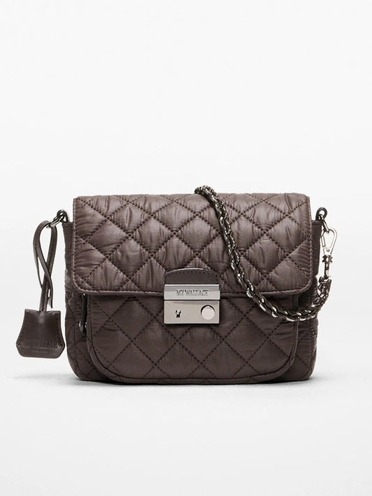 The MZ Wallace Crosby Lock Small Crossbody in Espresso Oxford features dark brown quilted fabric, a chain strap, silver-tone clasp closure, and a small pouch attached to the left side.