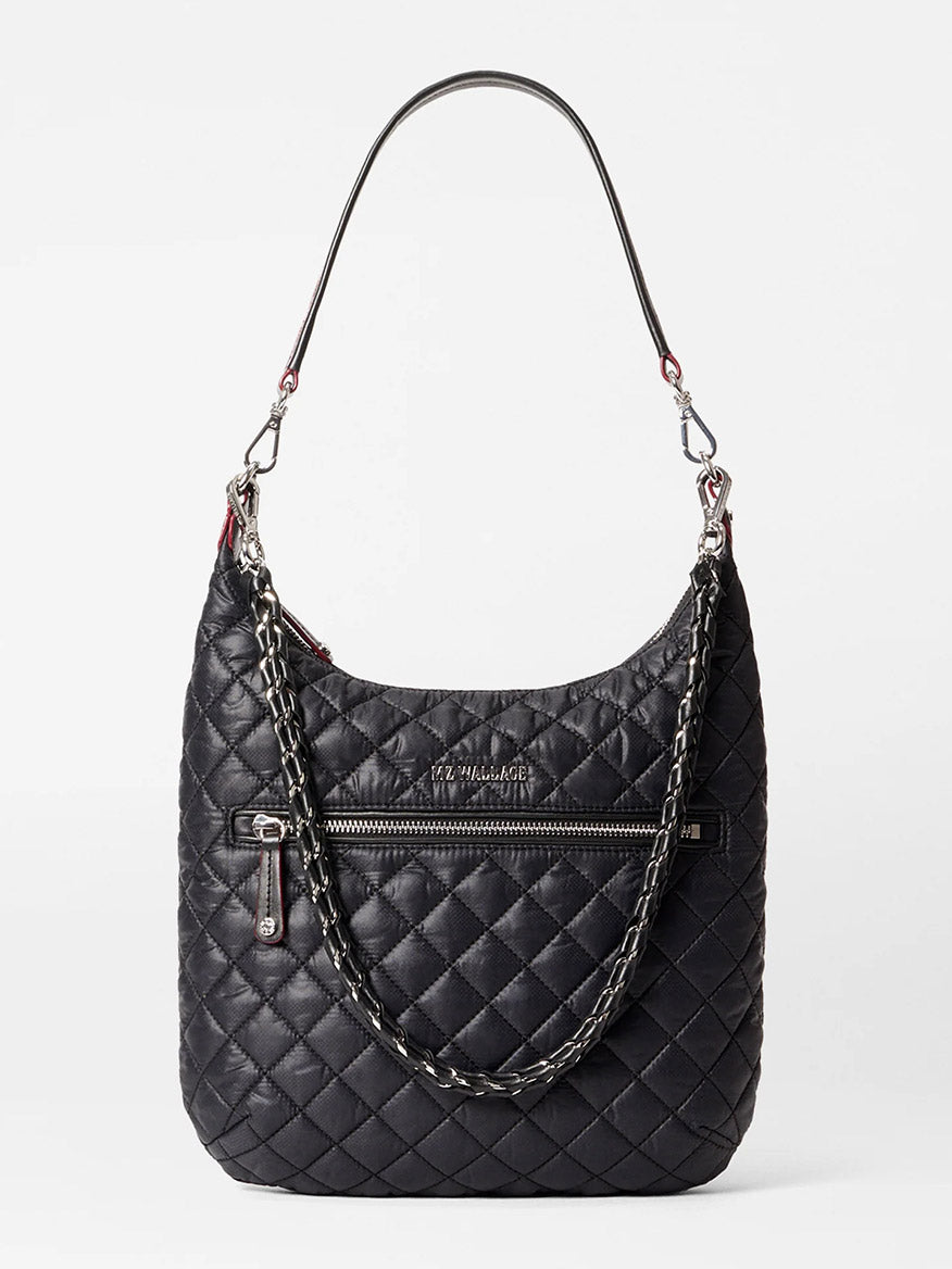 Check out the MZ Wallace Crosby Sienna in Black Oxford, a black quilted handbag made from premium Italian leather. It has a detachable chain strap and a front zipper pocket with "THE MARC JACOBS" embossed on one side, offering an ideal mix of style and function.