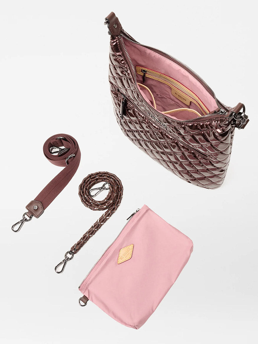 The MZ Wallace Crosby Sienna in Bordeaux Lacquer Oxford features a brown quilted exterior, pink interior, matching pouch, fabric and braided straps, displayed on a white background.