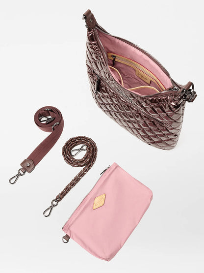 The MZ Wallace Crosby Sienna in Bordeaux Lacquer Oxford features a brown quilted exterior, pink interior, matching pouch, fabric and braided straps, displayed on a white background.