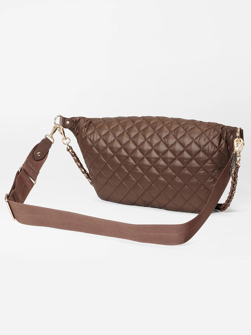 The MZ Wallace Crosby Crossbody Sling Bag in Walnut Oxford features a quilted design, a wide adjustable strap, and gold-tone hardware for a sleek hands-free look, showcased against a plain white background.