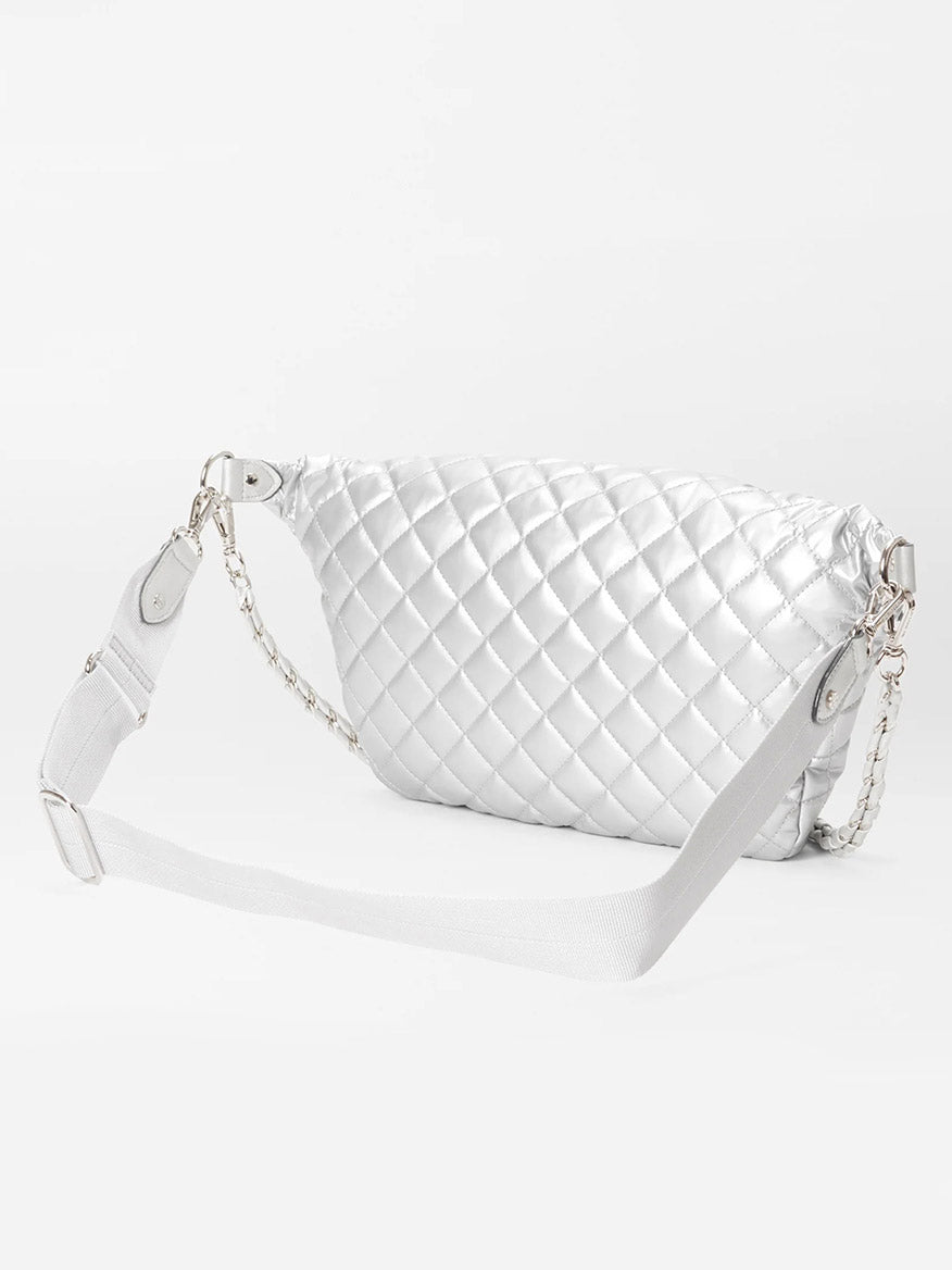 MZ Wallace Crosby Crossbody Sling Bag in Matte Silver Oxford with a silver chain strap and an adjustable shoulder strap, offering versatile hands-free options, set against a plain white background.