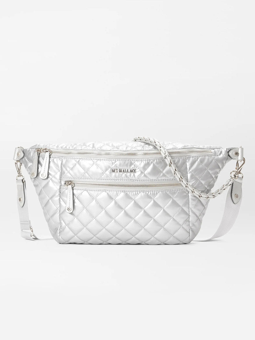 The MZ Wallace Crosby Crossbody Sling Bag in Matte Silver Oxford features a quilted design with an adjustable strap, zippered pockets, and a textured finish, providing versatile styling options for various ways to wear.