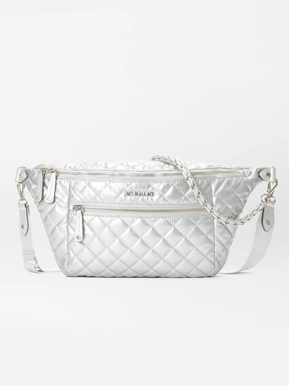 The MZ Wallace Crosby Crossbody Sling Bag in Matte Silver Oxford features a quilted design with an adjustable strap, zippered pockets, and a textured finish, providing versatile styling options for various ways to wear.