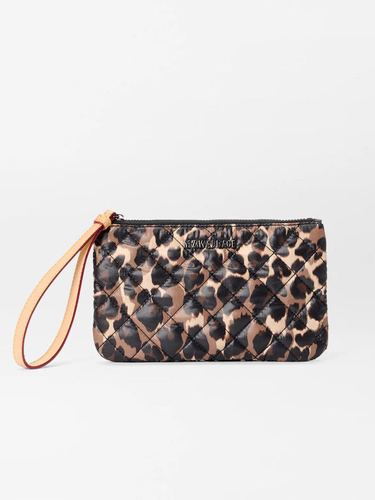 The MZ Wallace Flat Metro Wristlet in Leopard Oxford is a small quilted pouch with a tan strap, showcasing a bold leopard print pattern, displayed against a plain white background.
