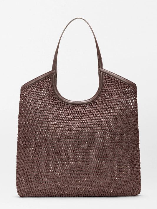 The MZ Wallace Large Crochet Georgica Tote in Brown Crochet features two handles, an open top, gold hardware accents, and is shown against a plain light background.