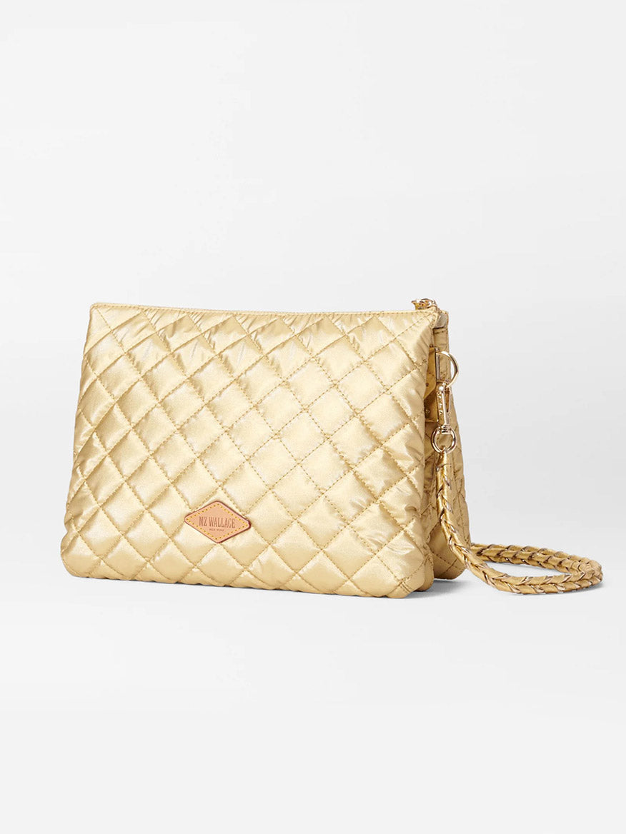 A MZ Wallace Large Crosby Pippa in Light Gold Pearl Metallic Oxford with an adjustable chain strap and a small logo tag on the front, featuring elegant Italian leather trim.