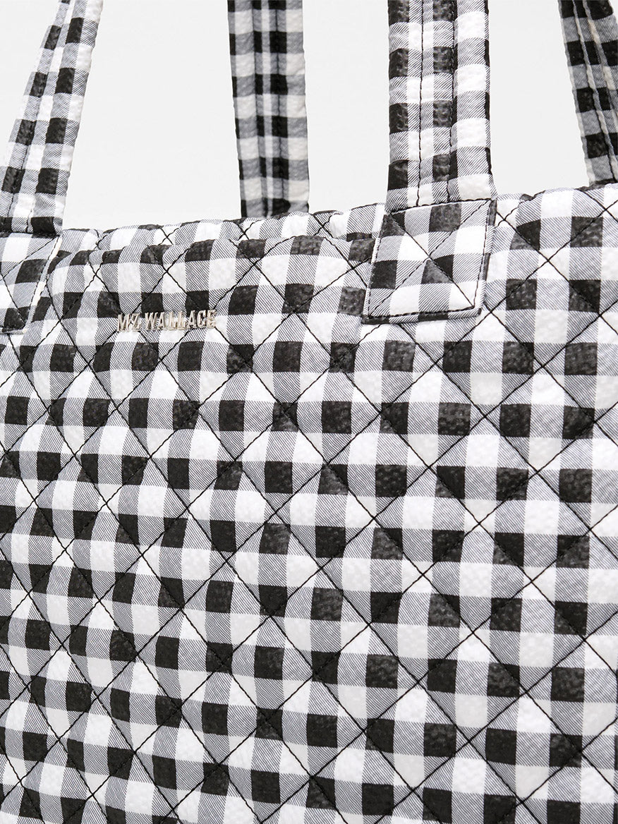Close-up of the MZ Wallace Large Metro Tote Deluxe in Black/White Gingham Oxford, featuring a quilted gingham pattern—perfect as a travel-ready tote.