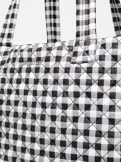 Close-up of the MZ Wallace Large Metro Tote Deluxe in Black/White Gingham Oxford, featuring a quilted gingham pattern—perfect as a travel-ready tote.