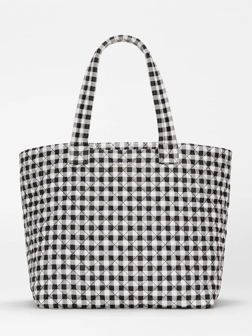 The MZ Wallace Large Metro Tote Deluxe in Black/White Gingham Oxford features a travel-ready design with two handles, shown against a plain white background.