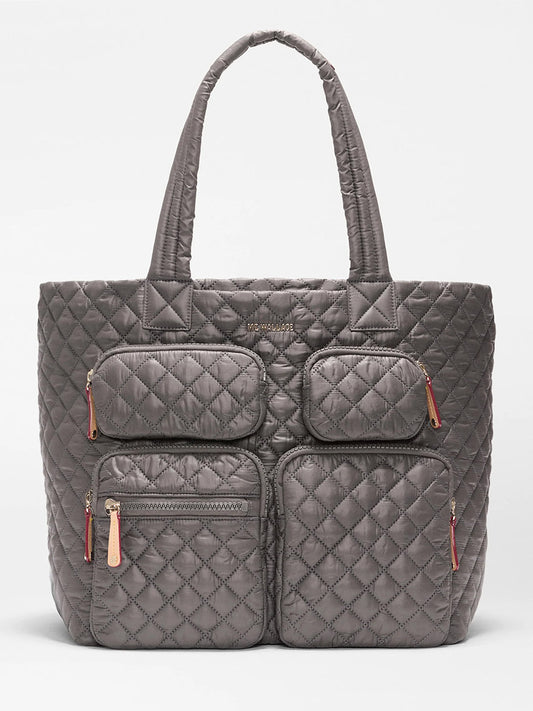 The MZ Wallace Large Metro Travel Tote in Magnet Oxford features durable quilted Oxford fabric, four front zippered pockets, and two shoulder straps, shown against a plain white background.